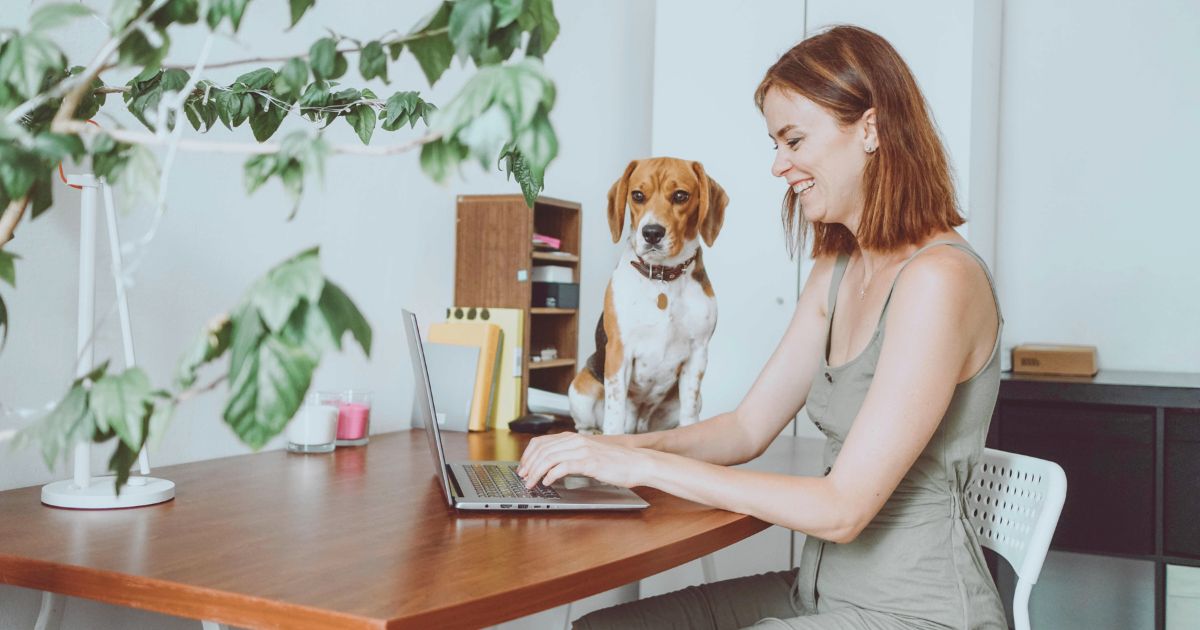 digital nomad woman working from home with her pet