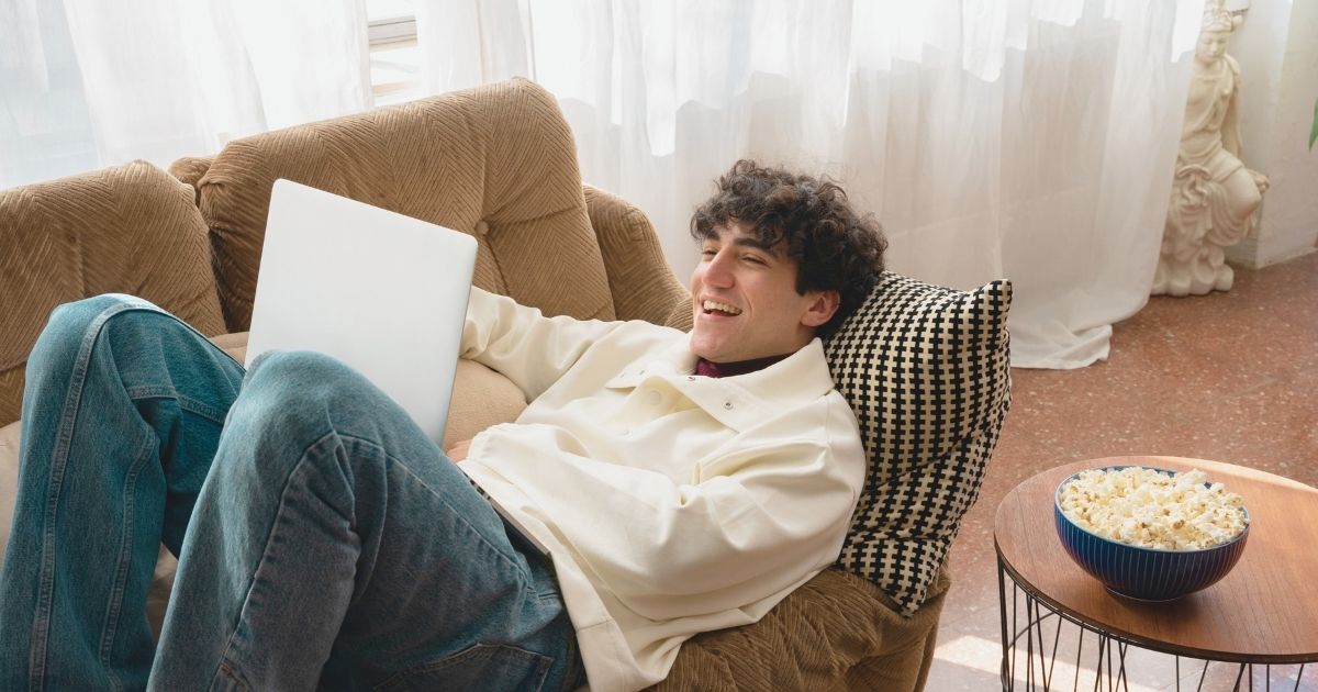 young man watching a documentary about digital nomads