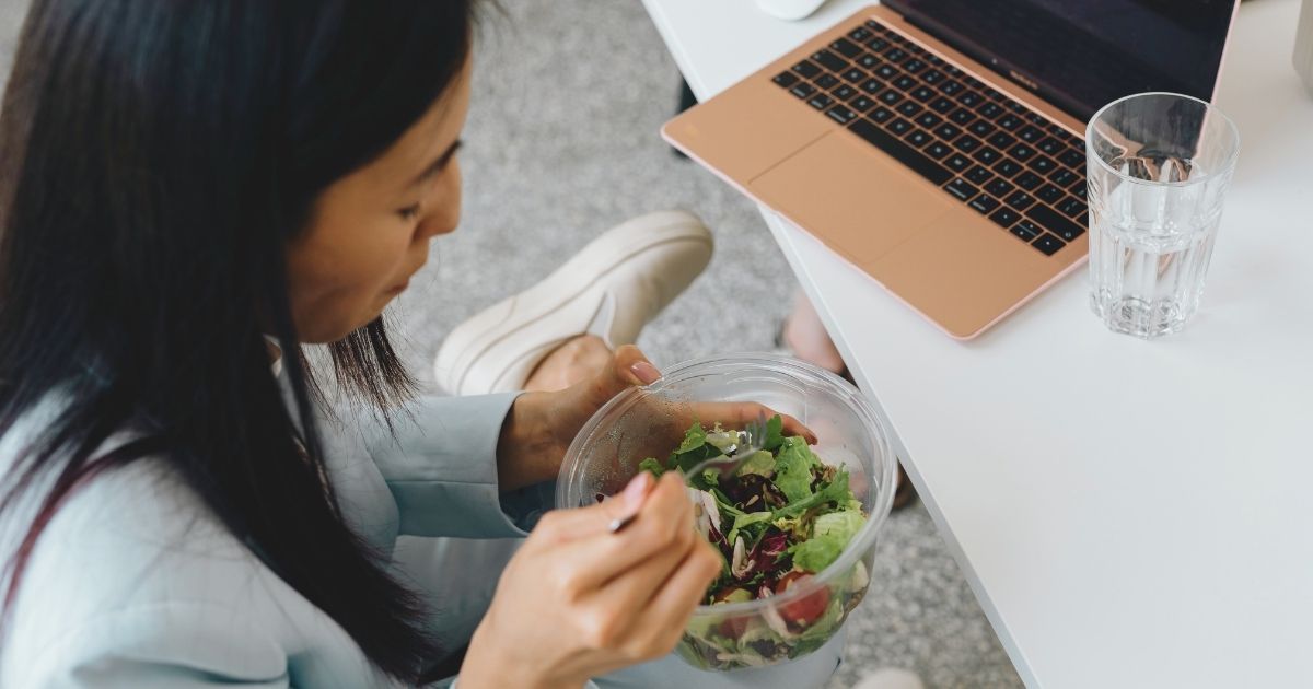 mujer nomada digital almorzando saludable