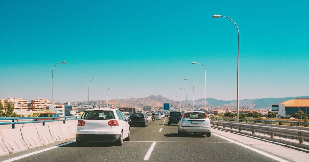 people driving a car in a road in Spain