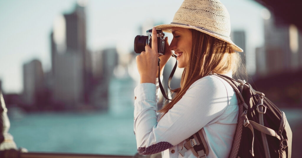 young tourist woman taking a picture during a trip