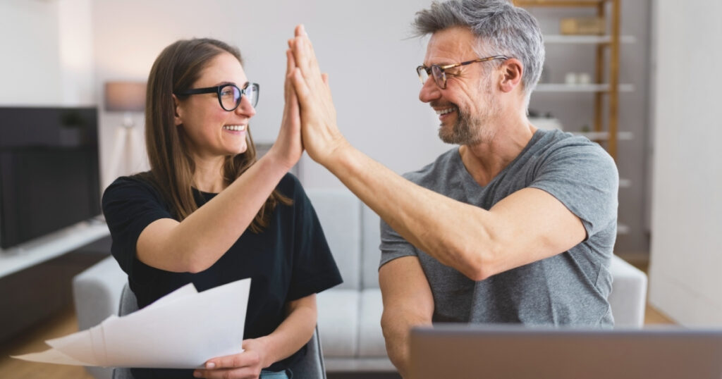 couple celebrating the capital gains and investment incomes