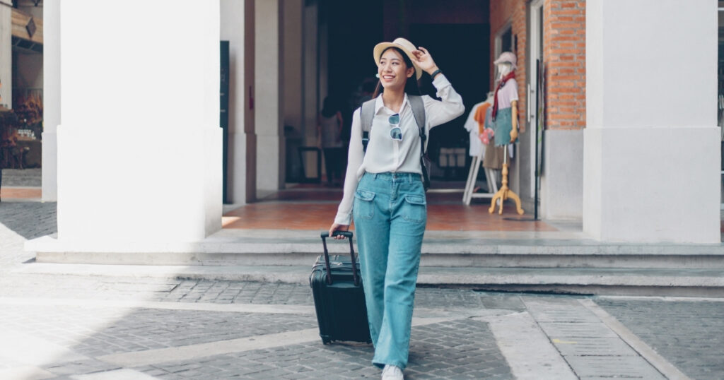 young woman traveling with a travel itinerary