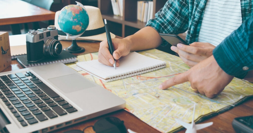 man creating a travel itinerary with the step-by-step guide