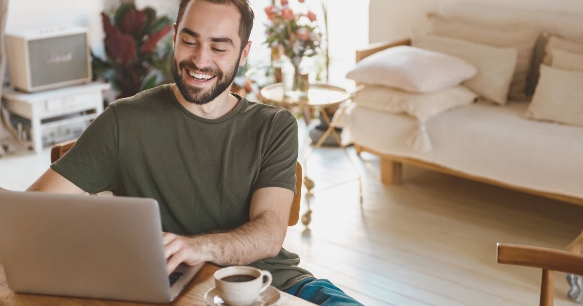 smiling man using the best tools to work remotely