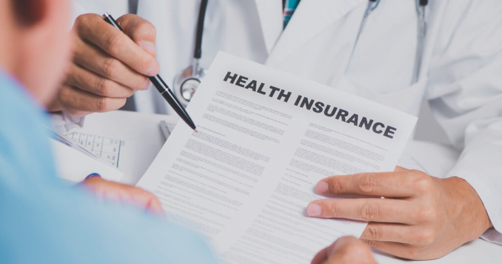 health insurance document being signed