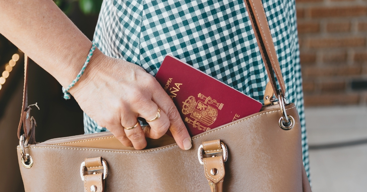 woman putting her passport in her bag