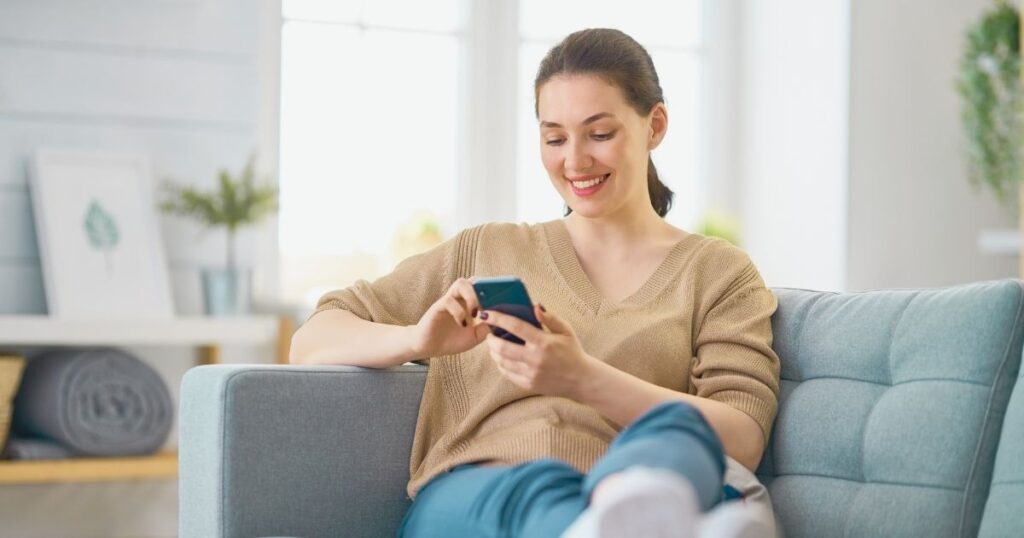 woman using her smartphone safely with an esim
