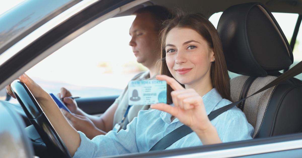 young woman showing her driving licence in the UK