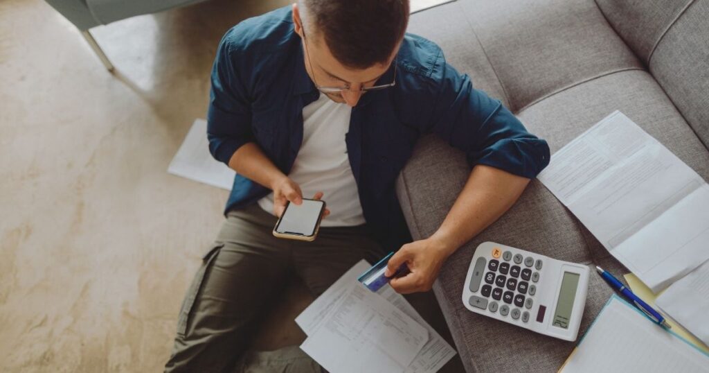 man calculating and comparing the different options to open a bank account in Germany
