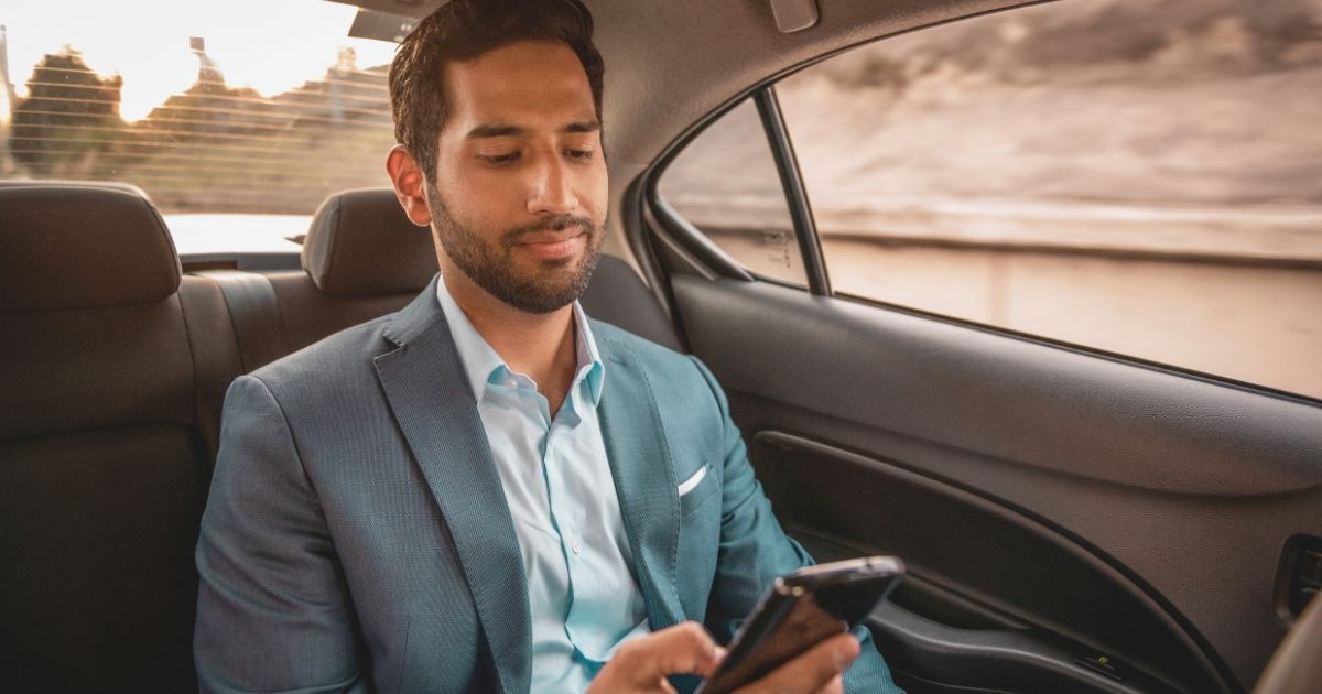 man navigating on internet with an esim for cars
