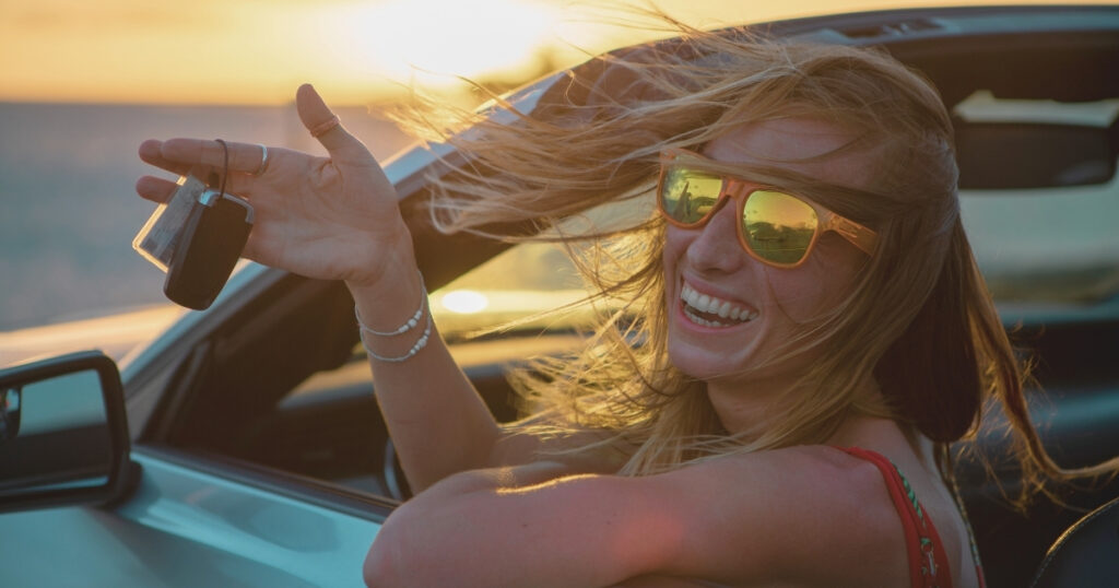 young woman driving a rental car in the US