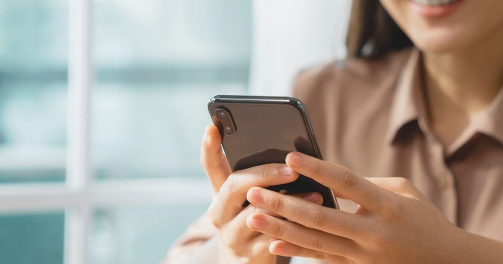 woman using internet in her mobile device in Spain