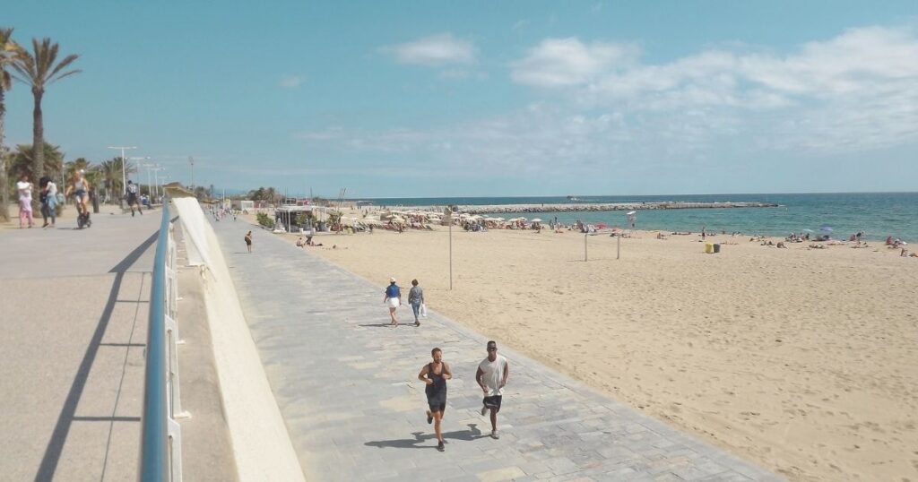 digital nomad people running in a Barcelona beach
