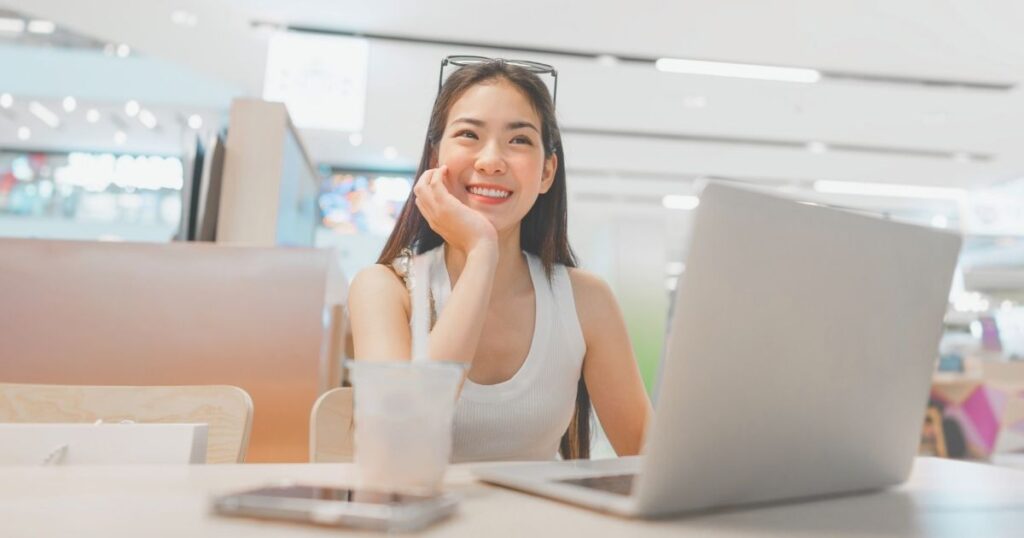 smiling digital nomad woman working remotely