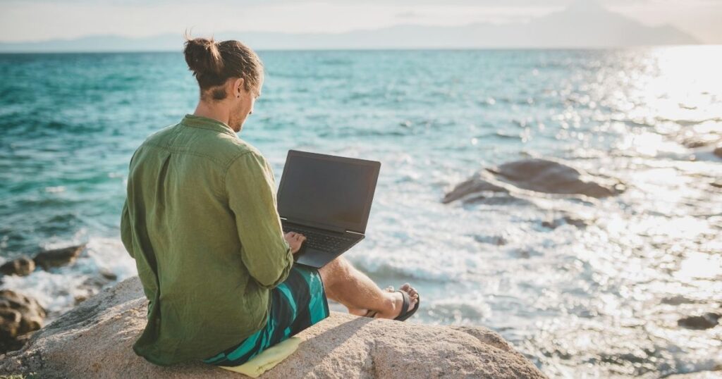 digital nomad man working from Bali beach