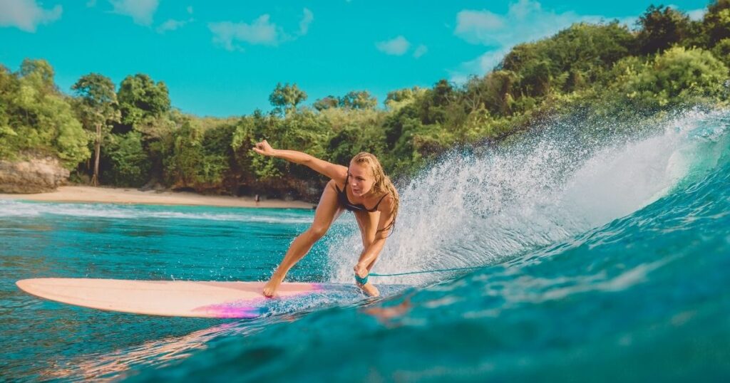 woman surfing in a Bali beach