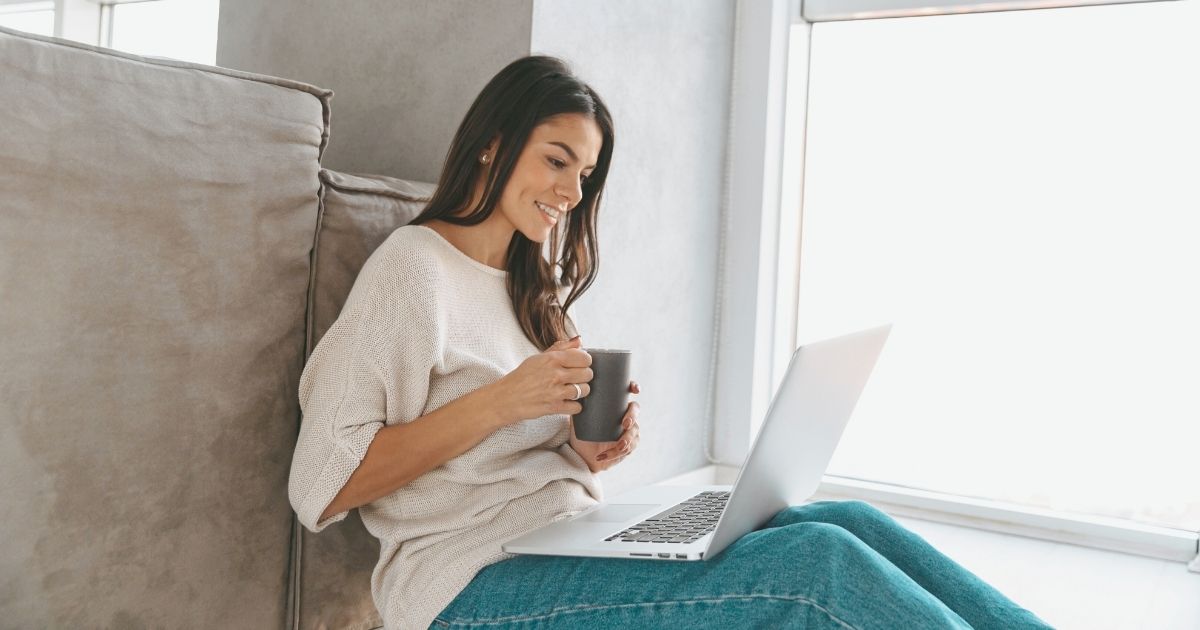 smiling woman using internet in her laptop in Australia