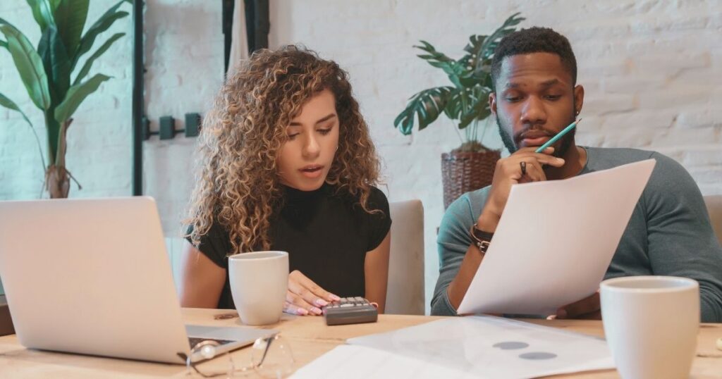 couple calculating the money-saving of living in Bali