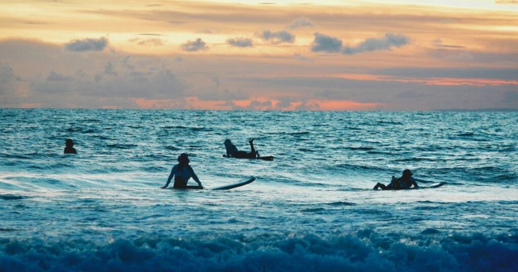 friends surfing in Bali beach