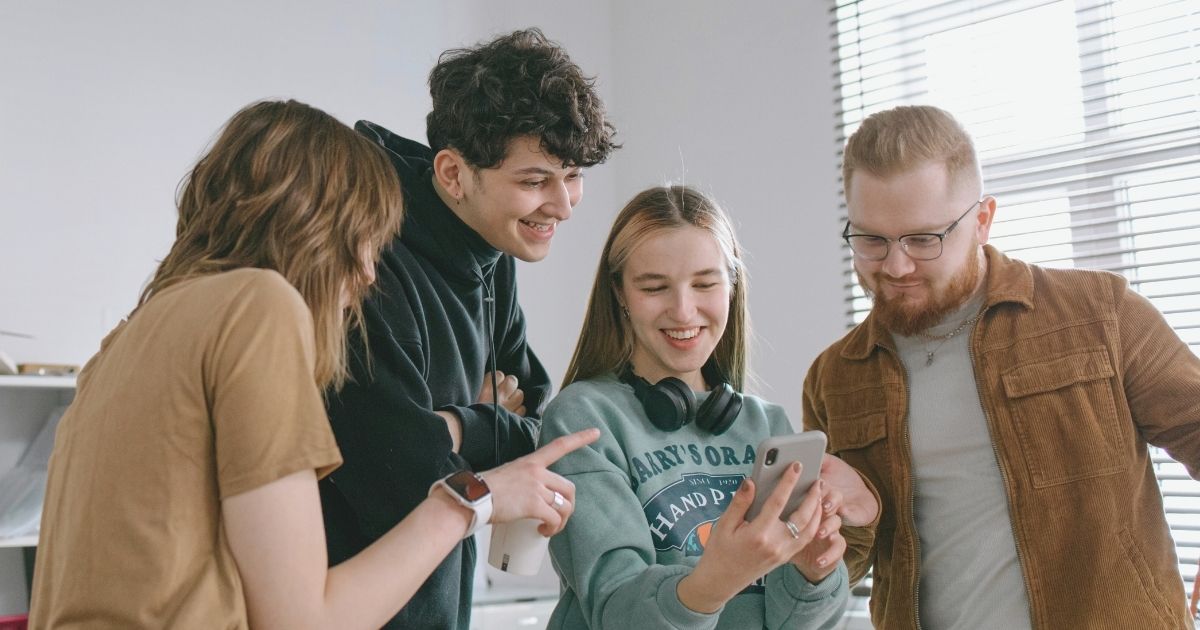 happy friends navigating on internet in Barcelona