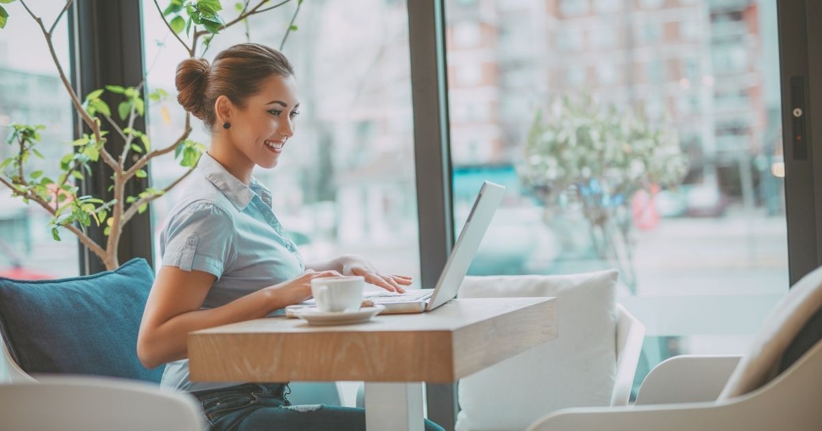 smiling woman using internet in London for working