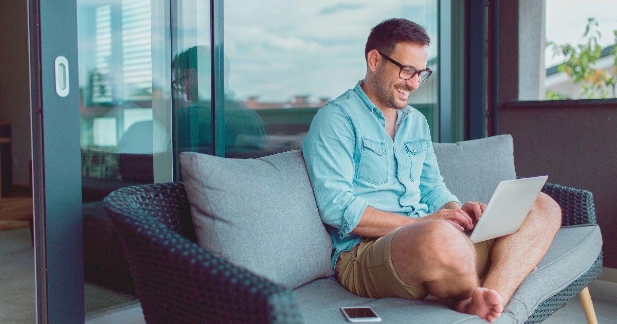 smiling man navigating on internet in New York