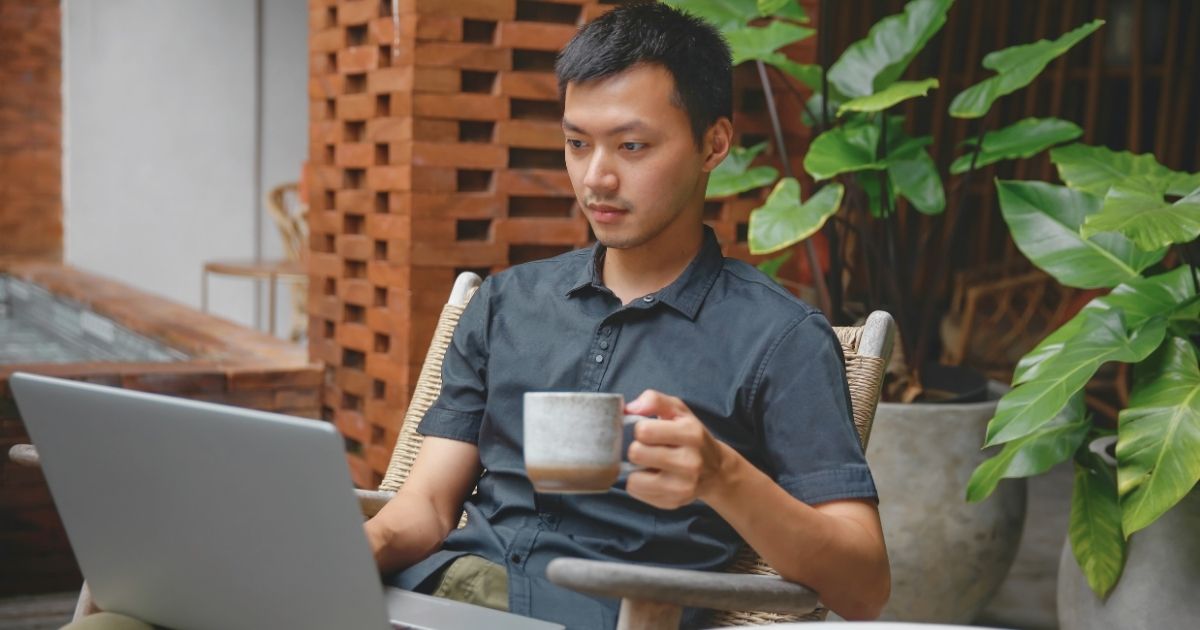 asian man working remotely using internet in Paris
