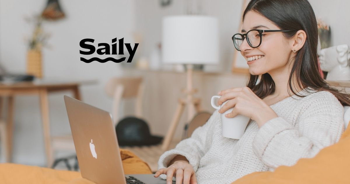 smiling woman using internet in her laptop with Saily esim