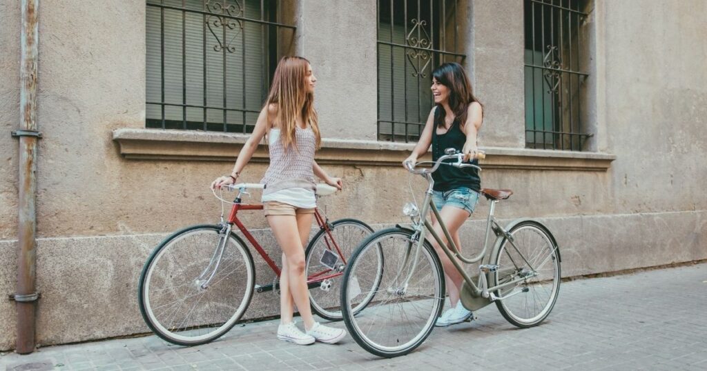 young women riding a rental bike in the Barcelona streets