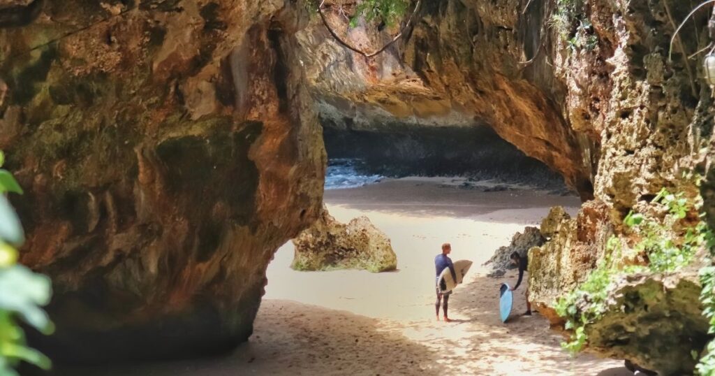 people going surfing and swimming in a Bali beach