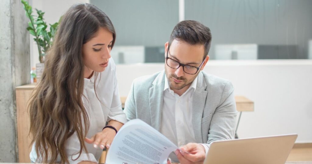 man signing health insurance form in Finland