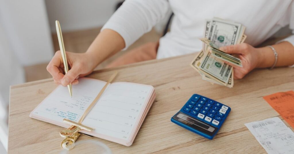 woman calculating costs to apply to the Golden Visa in Portugal
