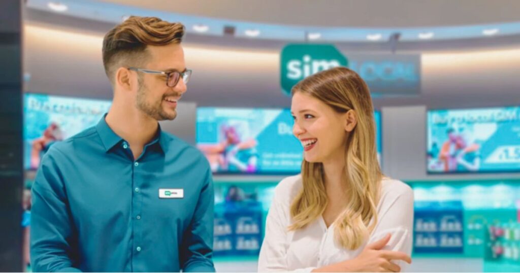 hombre de atencion al cliente de Simlocal atendiendo mujer en la tienda