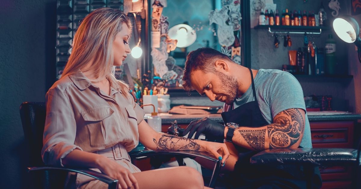 young woman making a tattoo in one of the best studios in Bali