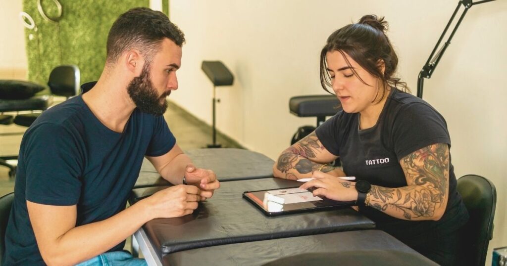 man making a tattoo booking in Bali