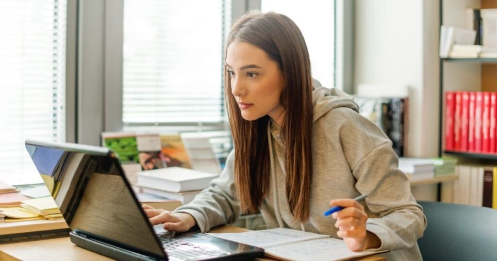 student woman calculating costs to get internet in her laptop