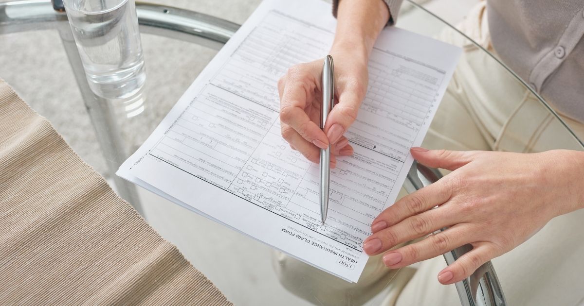 person reading and signing a health insurance for Hungary