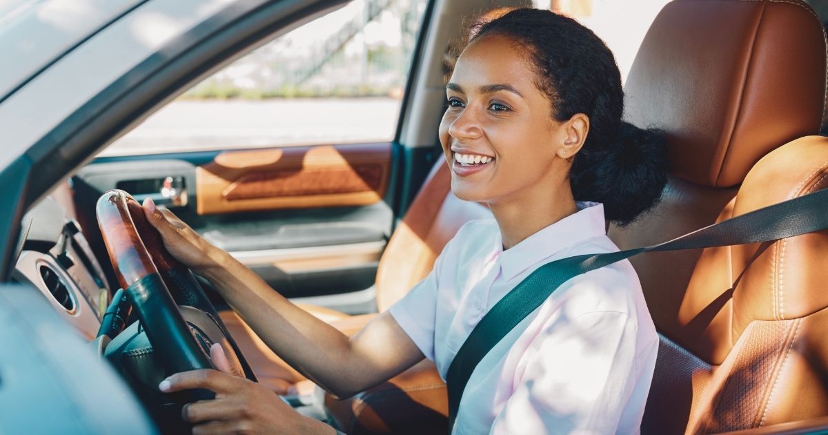 smiling woman driving a rented car in South Africa